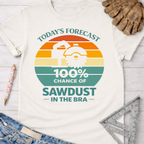 Women's funny woodworking graphic tee shirt for female woodworkers, makers, and DIY builders — Sawdust & Ponytails. White cotton t-shirt with a retro sunset graphic and text "Today's Forecast: 100% Chance of Sawdust in the Bra.