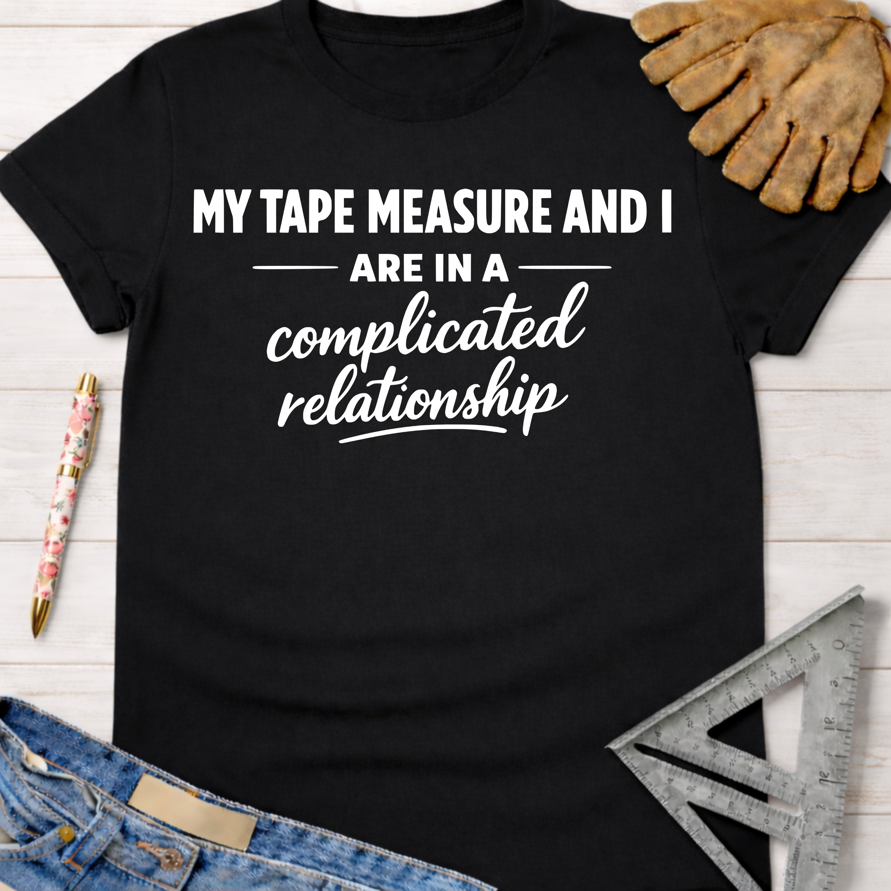 Black cotton tee with "My Tape Measure And I Are In A Complicated Relationship" in white text. Women's funny woodworking graphic tee shirt for female woodworkers, makers, and DIY builders — Sawdust & Ponytails