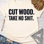 Women's funny woodworking graphic tee shirt for female woodworkers, makers, and DIY builders — Sawdust & Ponytails. Cream short-sleeve t-shirt with "CUT WOOD. TAKE NO SHIT." in black text.