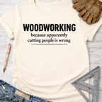 Women's funny woodworking graphic tee shirt for female woodworkers, makers, and DIY builders — Sawdust & Ponytails. Cream t-shirt with "WOODWORKING because apparently cutting people is wrong" in black text.