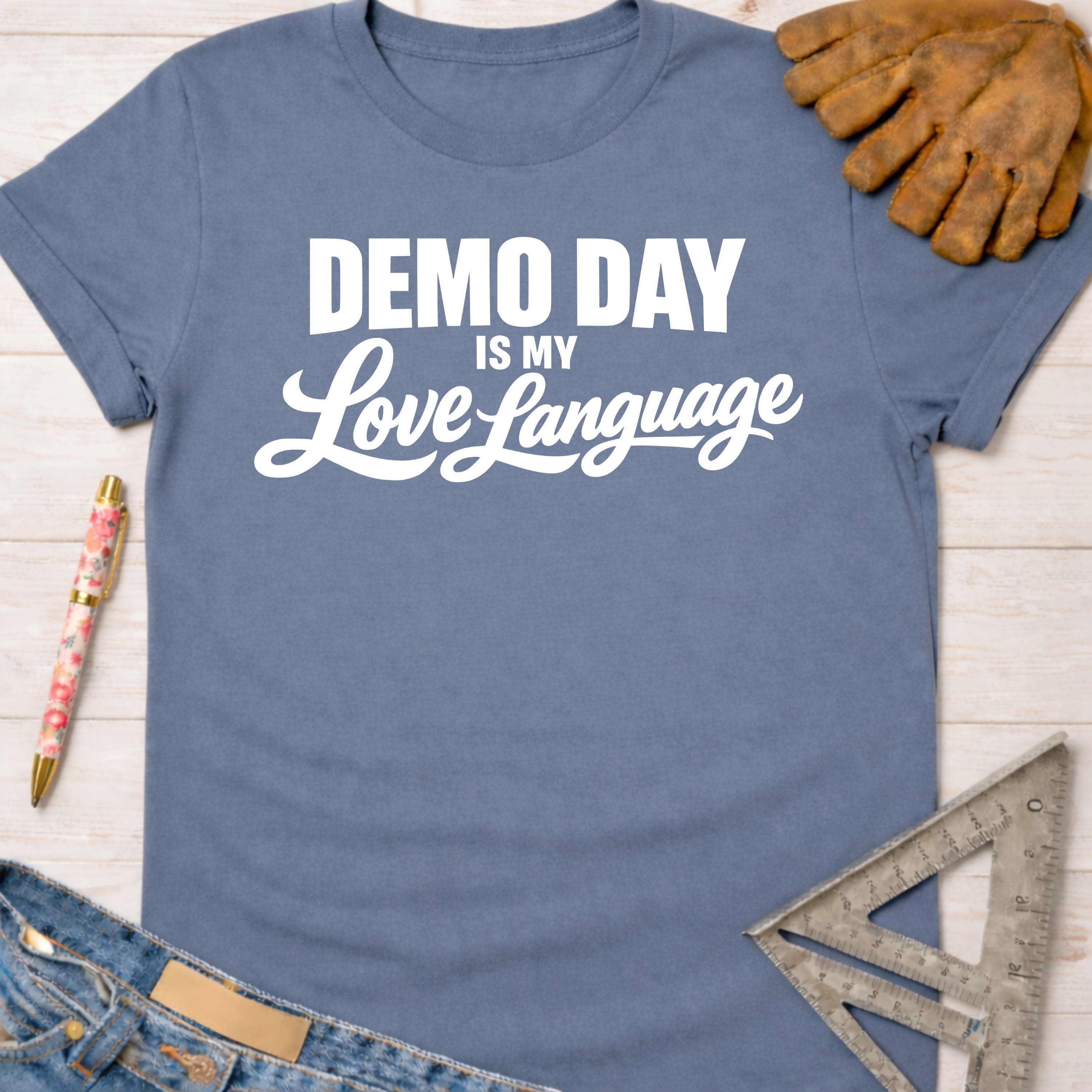 Women's funny woodworking graphic tee shirt for female woodworkers, makers, and DIY builders — Sawdust & Ponytails. Blue cotton t-shirt with "Demo Day Is My Love Language" in white text.