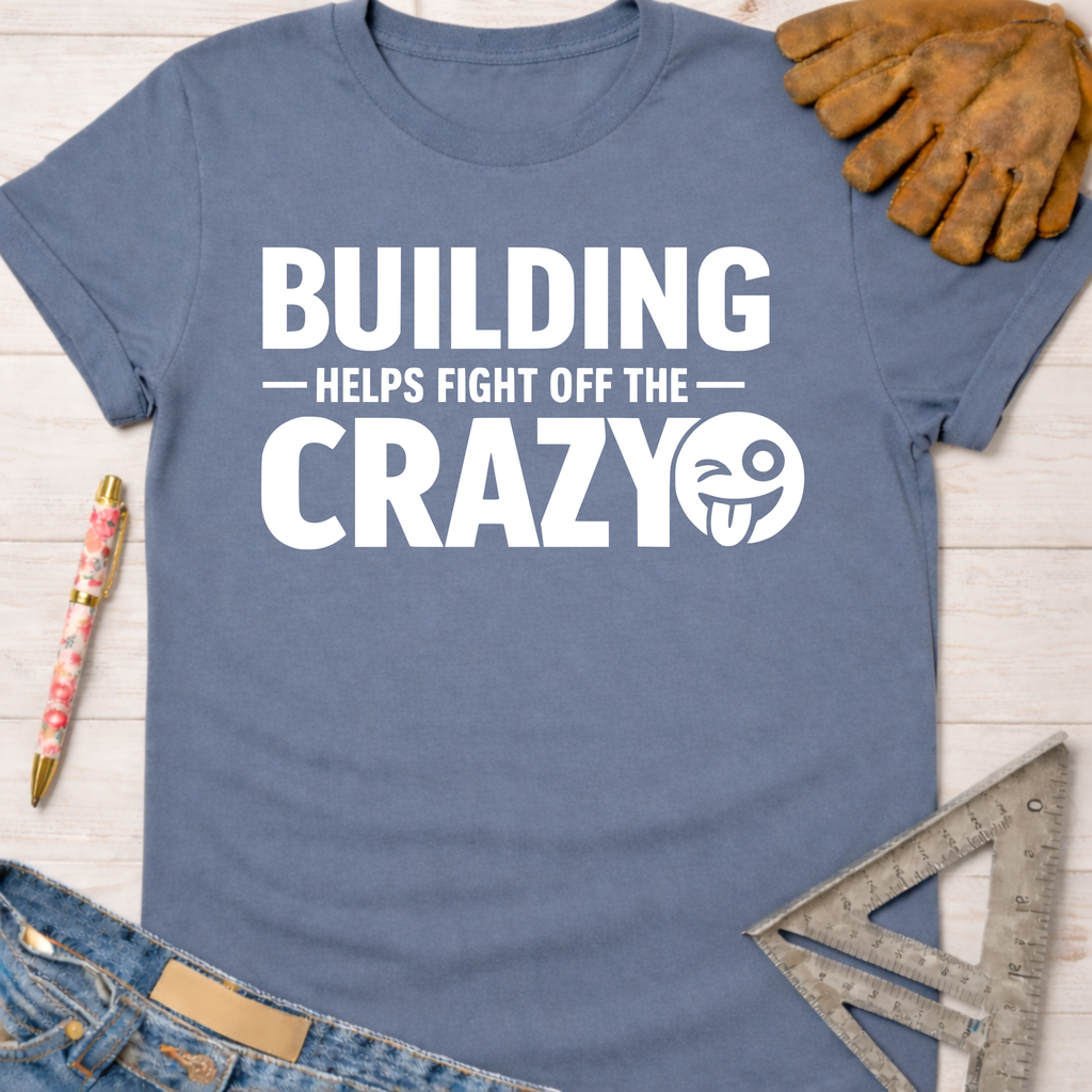 Women's funny woodworking graphic tee shirt for female woodworkers, makers, and DIY builders — Sawdust & Ponytails. Blue cotton tee with "BUILDING HELPS FIGHT OFF THE CRAZY" graphic.