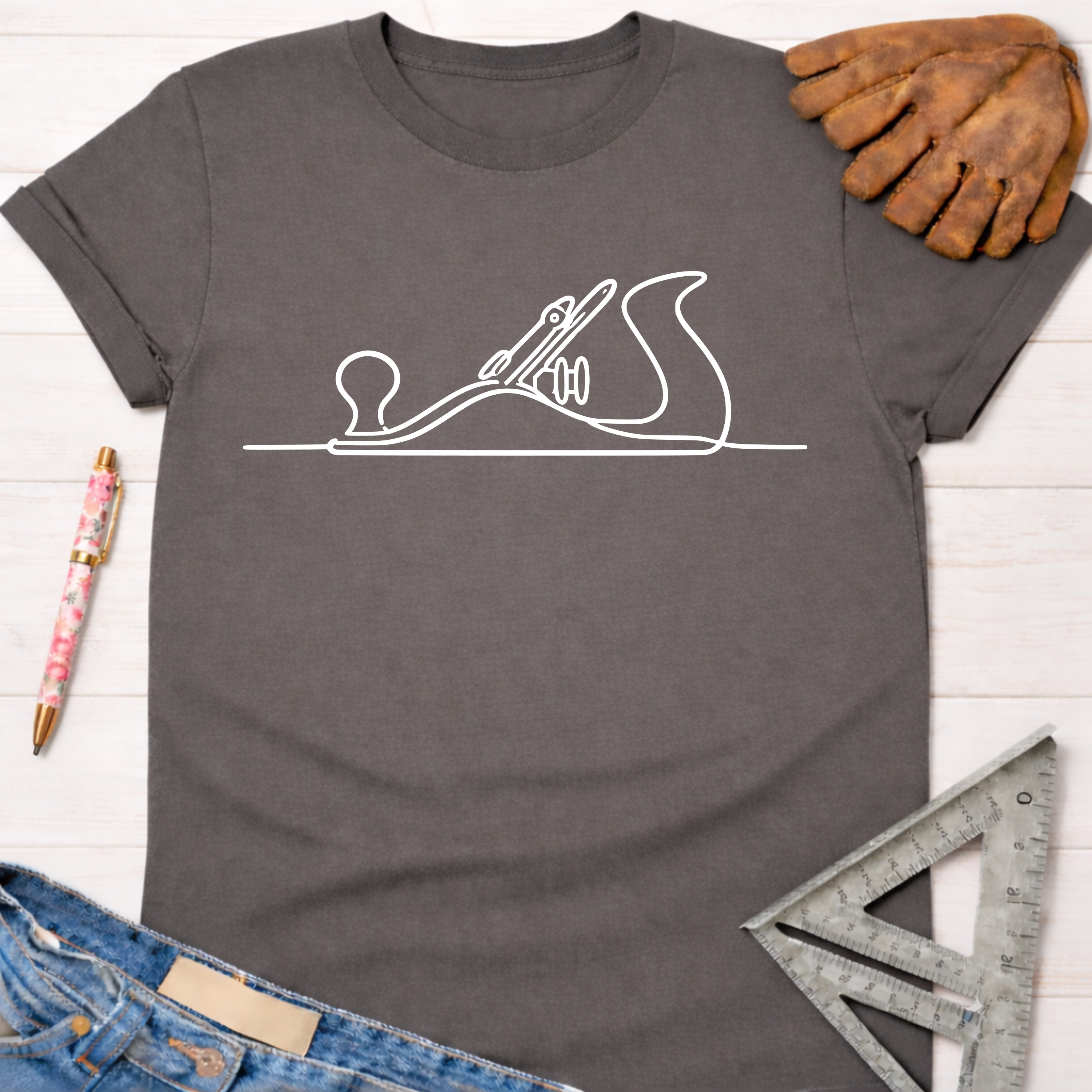 Charcoal gray women's tee with white hand planer line art. Women's funny woodworking graphic tee shirt for female woodworkers, makers, and DIY builders — Sawdust & Ponytails