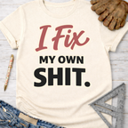Women's funny woodworking graphic tee shirt for female woodworkers, makers, and DIY builders — Sawdust & Ponytails. Cream t-shirt with "I Fix My Own Shit" text.