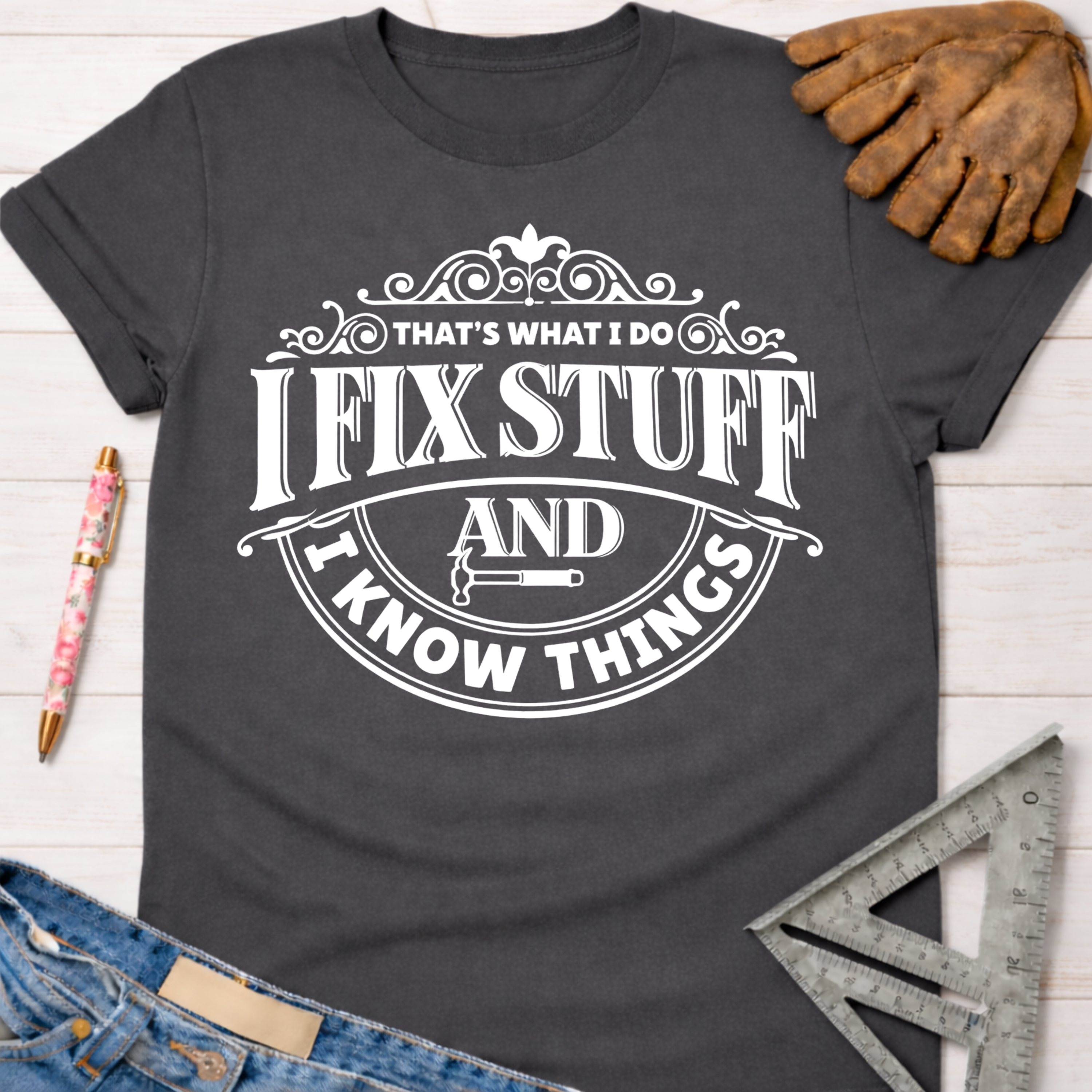 Women's funny woodworking graphic tee shirt for female woodworkers, makers, and DIY builders — Sawdust & Ponytails. Dark gray cotton tee with "I Fix Stuff & Know Things" text.