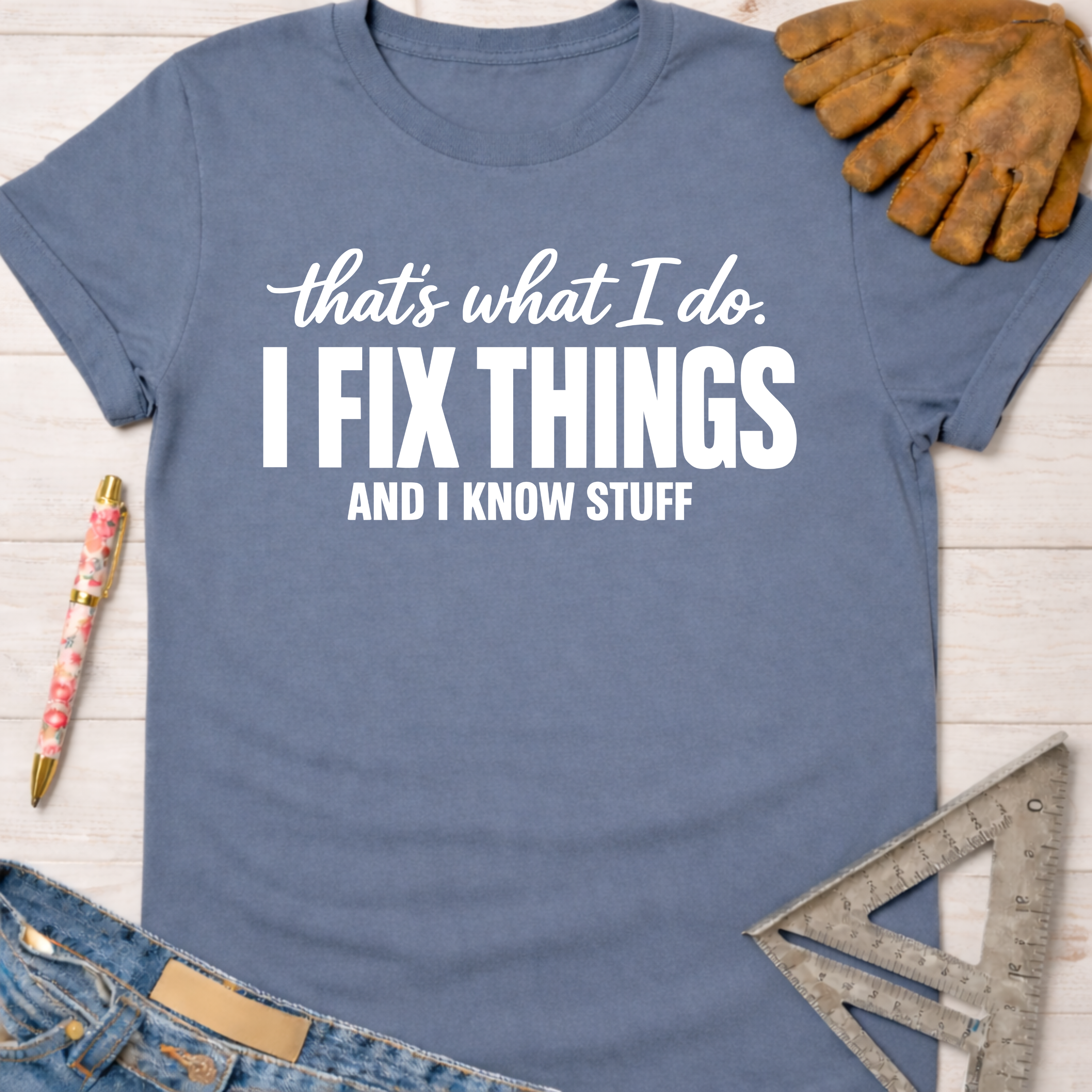 Women's funny woodworking graphic tee shirt for female woodworkers, makers, and DIY builders — Sawdust & Ponytails. Blue short-sleeve cotton tee with "I FIX THINGS AND I KNOW STUFF" in white text.