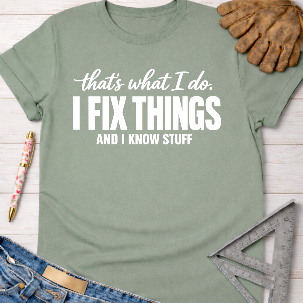 Sage green women's "I Fix Things And I Know Stuff" graphic tee, with work gloves, jeans, and tools. Women's funny woodworking graphic tee shirt for female woodworkers, makers, and DIY builders — Sawdust & Ponytails