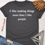 Charcoal grey cotton t-shirt with "I like making things more than I like people" in white text. Women's funny woodworking graphic tee shirt for female woodworkers, makers, and DIY builders — Sawdust & Ponytails