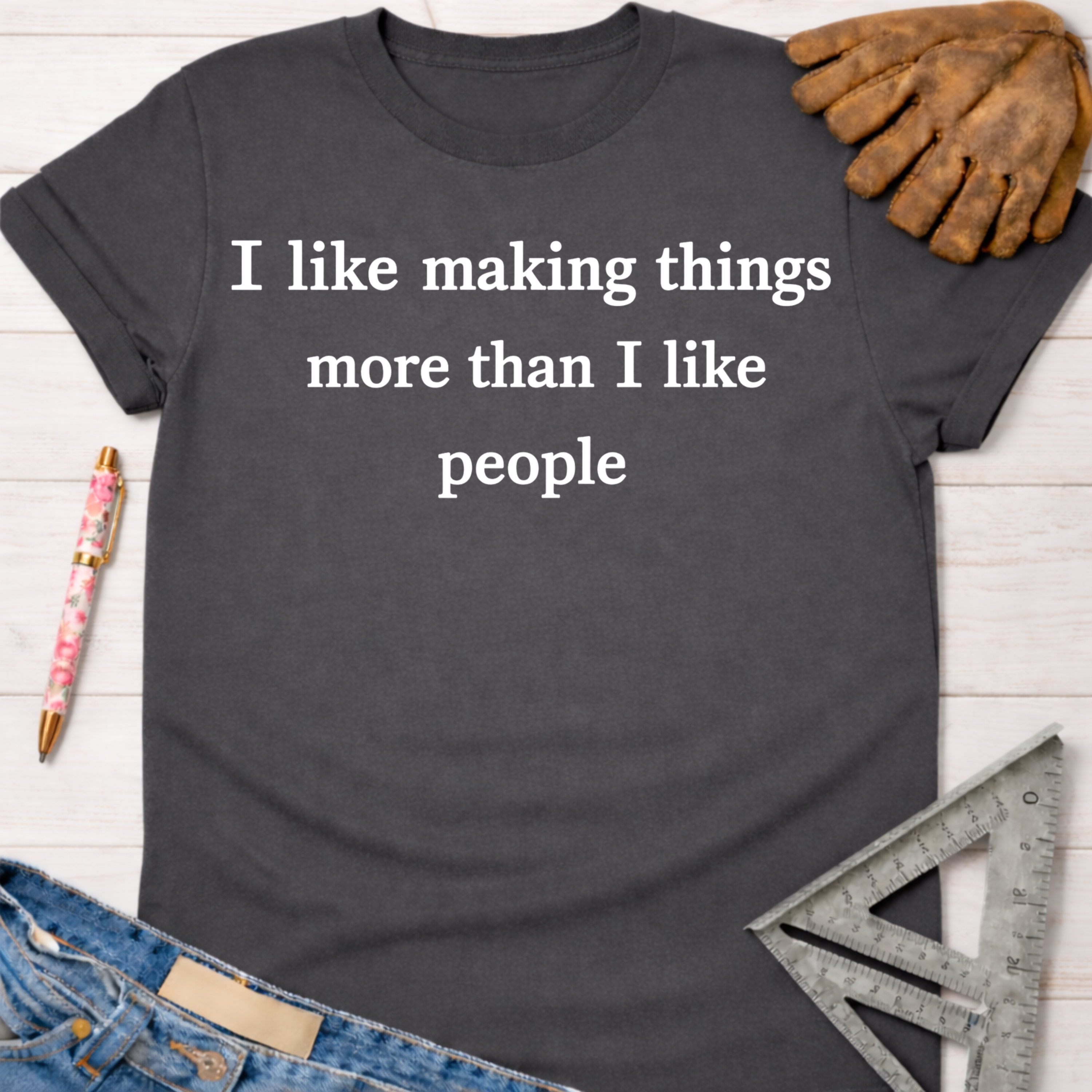 Charcoal grey cotton t-shirt with "I like making things more than I like people" in white text. Women's funny woodworking graphic tee shirt for female woodworkers, makers, and DIY builders — Sawdust & Ponytails