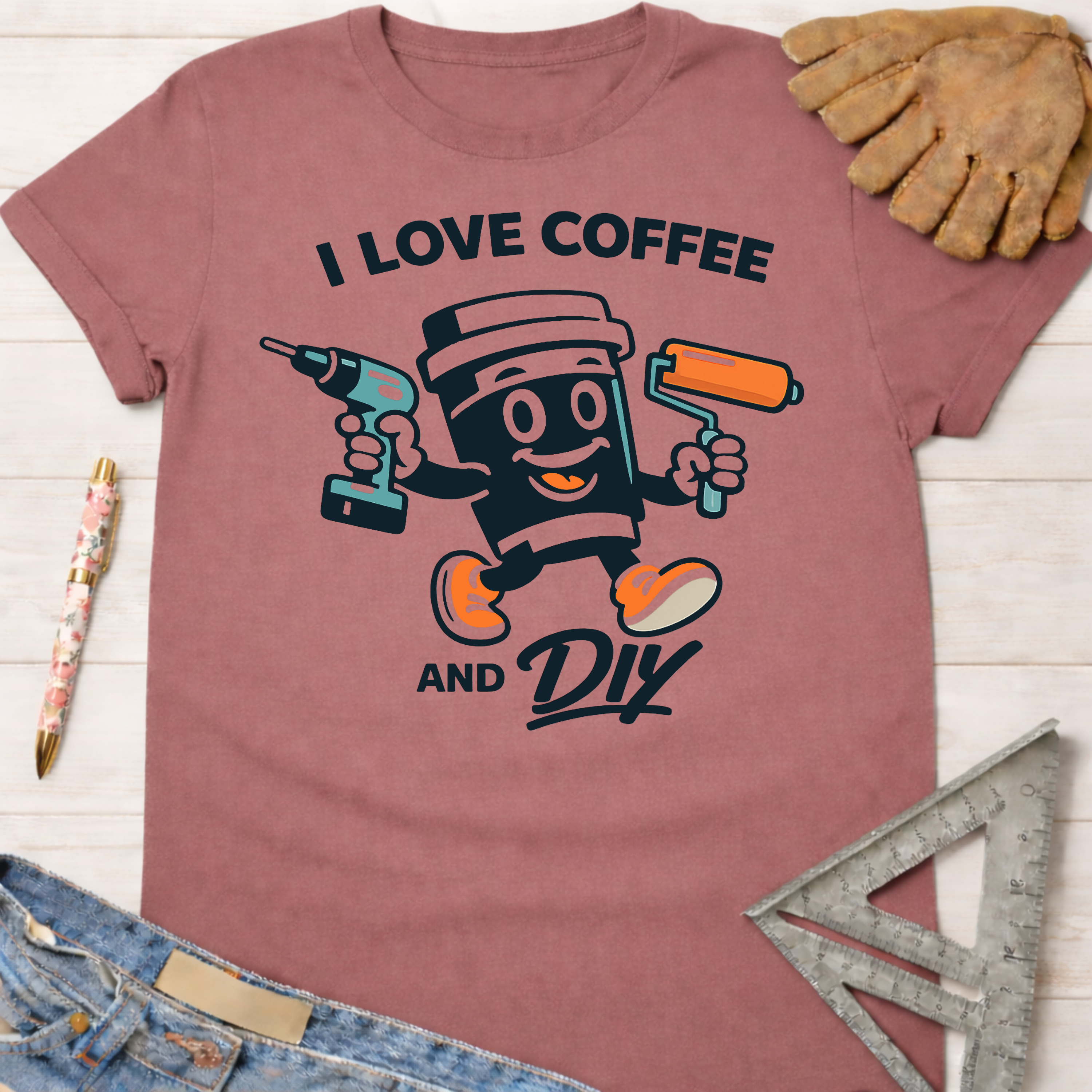Women's funny woodworking graphic tee shirt for female woodworkers, makers, and DIY builders — Sawdust & Ponytails. Mauve short-sleeve t-shirt with "I Love Coffee and DIY" graphic featuring a coffee cup holding a drill and paint roller.
