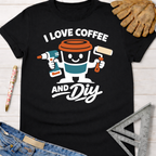 Women's funny woodworking graphic tee shirt for female woodworkers, makers, and DIY builders — Sawdust & Ponytails. Black cotton crewneck tee with "I Love Coffee and DIY" graphic featuring a coffee cup holding a drill and paint roller.