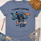 Women's funny woodworking graphic tee shirt for female woodworkers, makers, and DIY builders — Sawdust & Ponytails. Blue cotton t-shirt with "I Love Coffee and DIY" graphic featuring a coffee cup holding a drill and paint roller.