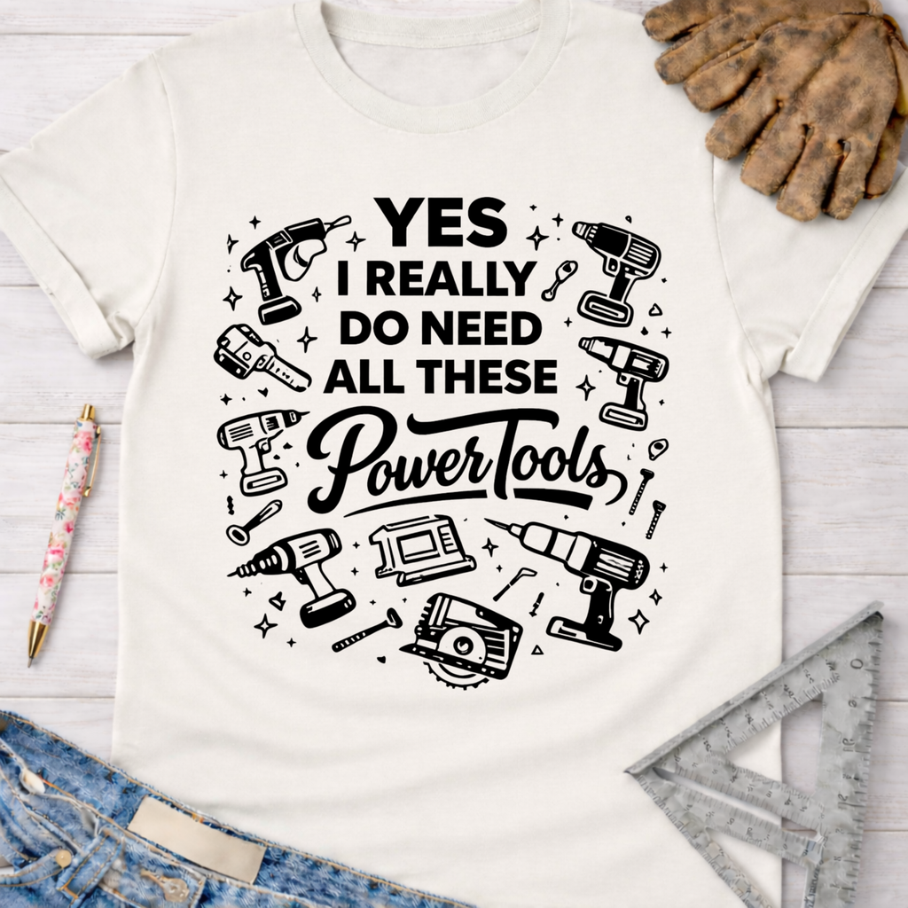 Women's funny woodworking graphic tee shirt for female woodworkers, makers, and DIY builders — Sawdust & Ponytails. White cotton t-shirt with "YES I REALLY DO NEED ALL THESE Power Tools" and tool illustrations.