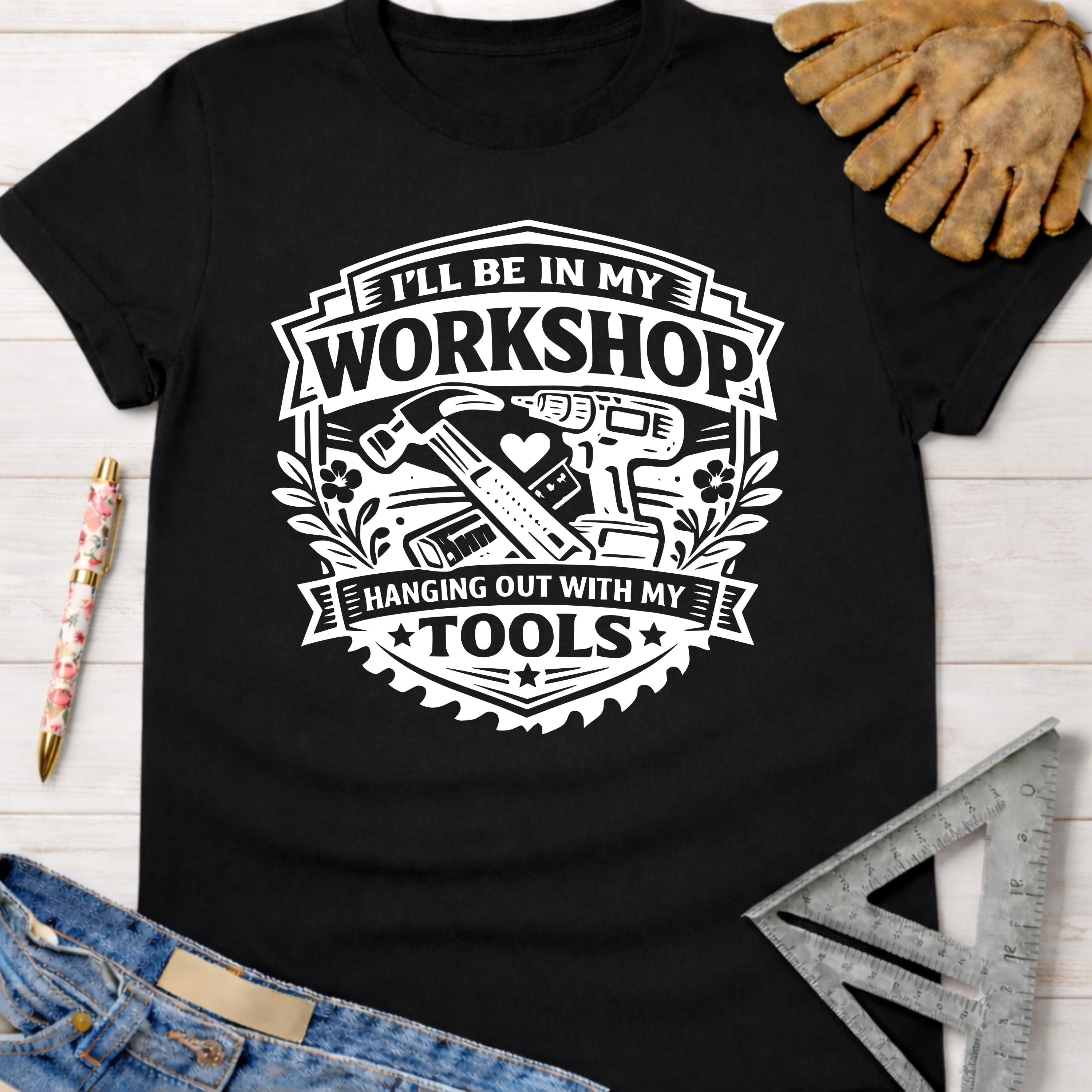 Women's funny woodworking graphic tee shirt for female woodworkers, makers, and DIY builders — Sawdust & Ponytails. Black cotton tee with white "I'll Be In My Workshop Hanging Out With My Tools" design featuring hammer, drill, and saw blade.