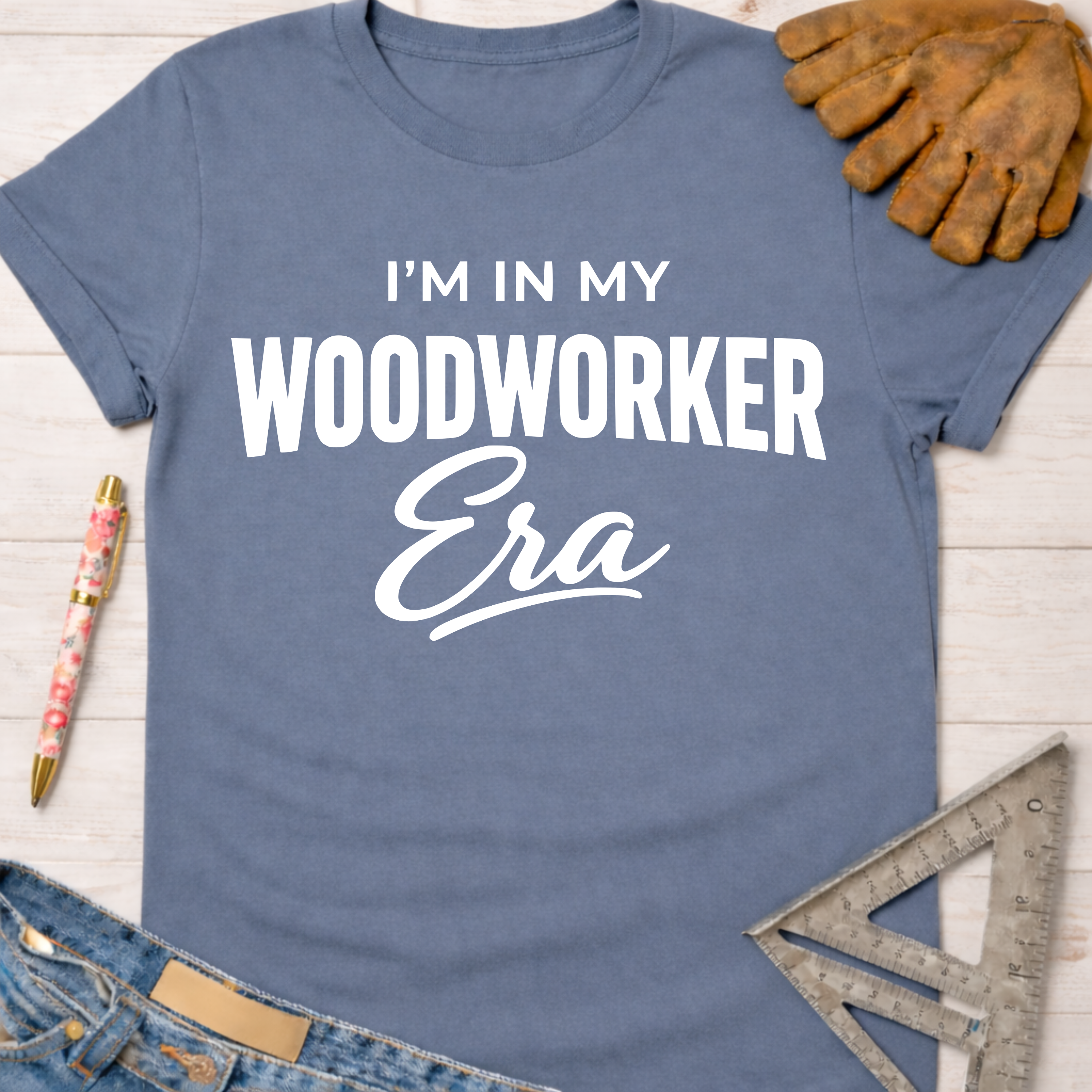 Women's funny woodworking graphic tee shirt for female woodworkers, makers, and DIY builders — Sawdust & Ponytails. Blue cotton tee with "I'm In My Woodworker Era" in white text.