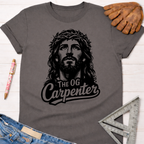 Women's funny woodworking graphic tee shirt for female woodworkers, makers, and DIY builders — Sawdust & Ponytails. Dark gray cotton tee with a black graphic of Jesus wearing a crown of thorns and "THE OG Carpenter" text.