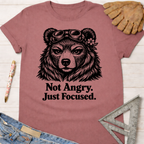 Women's funny woodworking graphic tee shirt for female woodworkers, makers, and DIY builders — Sawdust & Ponytails. Mauve tee with a bear wearing goggles and "Not Angry. Just Focused.