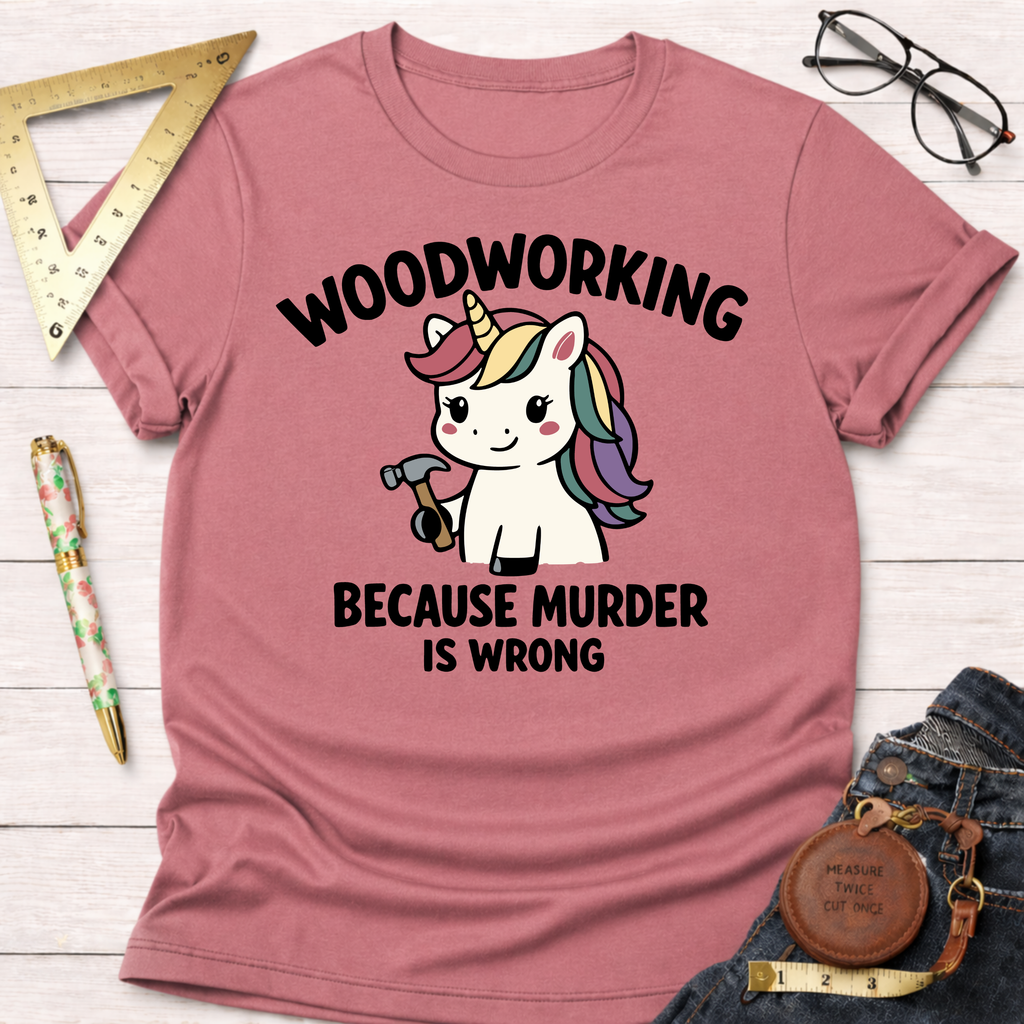 Women's funny woodworking graphic tee shirt for female woodworkers, makers, and DIY builders — Sawdust & Ponytails. Pink t-shirt with a unicorn holding a hammer and "Woodworking Because Murder Is Wrong" text.