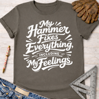 Women's funny woodworking graphic tee shirt for female woodworkers, makers, and DIY builders — Sawdust & Ponytails. Dark gray cotton tee with "My Hammer Fixes Everything, Including My Feelings" in white script.