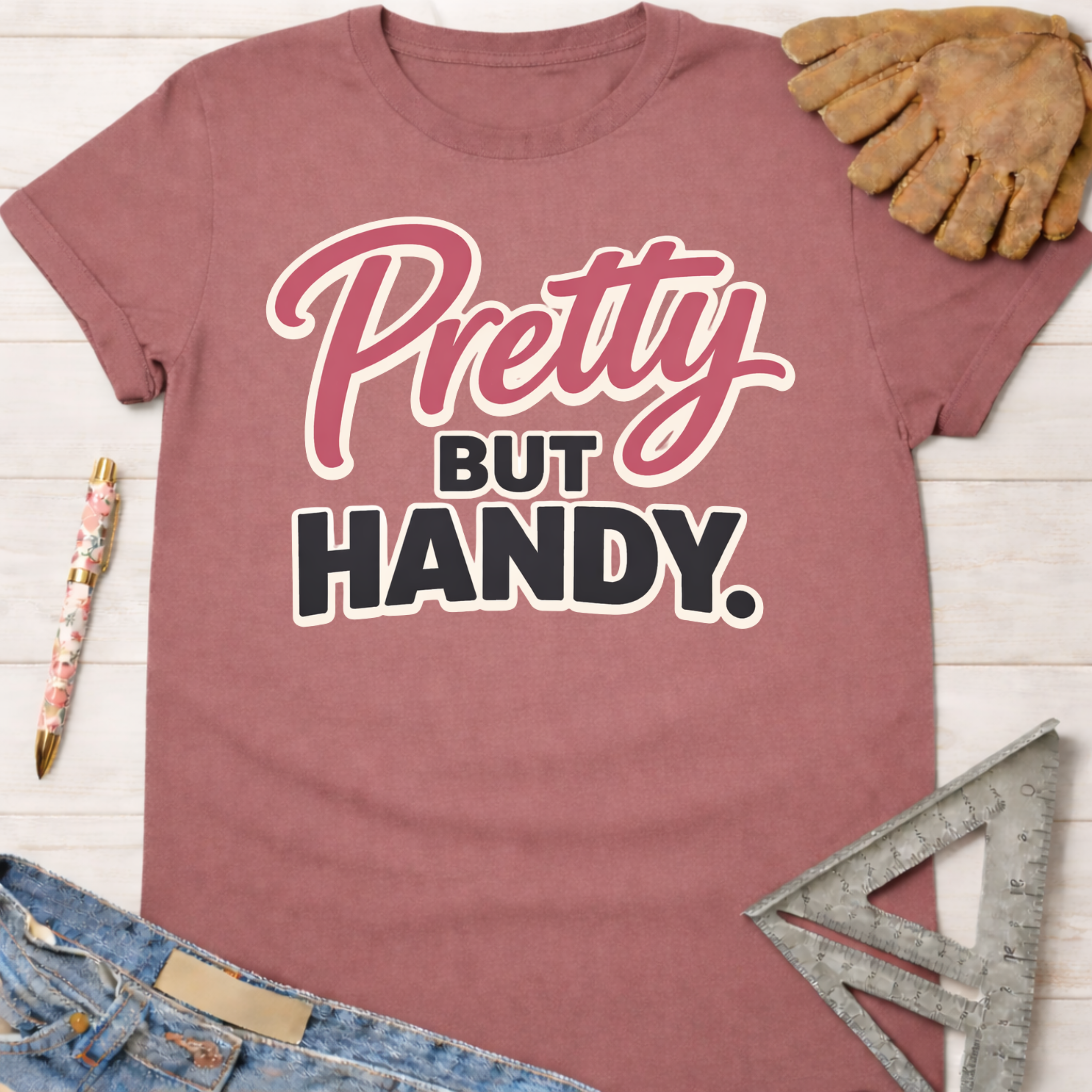 Women's funny woodworking graphic tee shirt for female woodworkers, makers, and DIY builders — Sawdust & Ponytails. Mauve pink cotton tee with "Pretty BUT HANDY" graphic.
