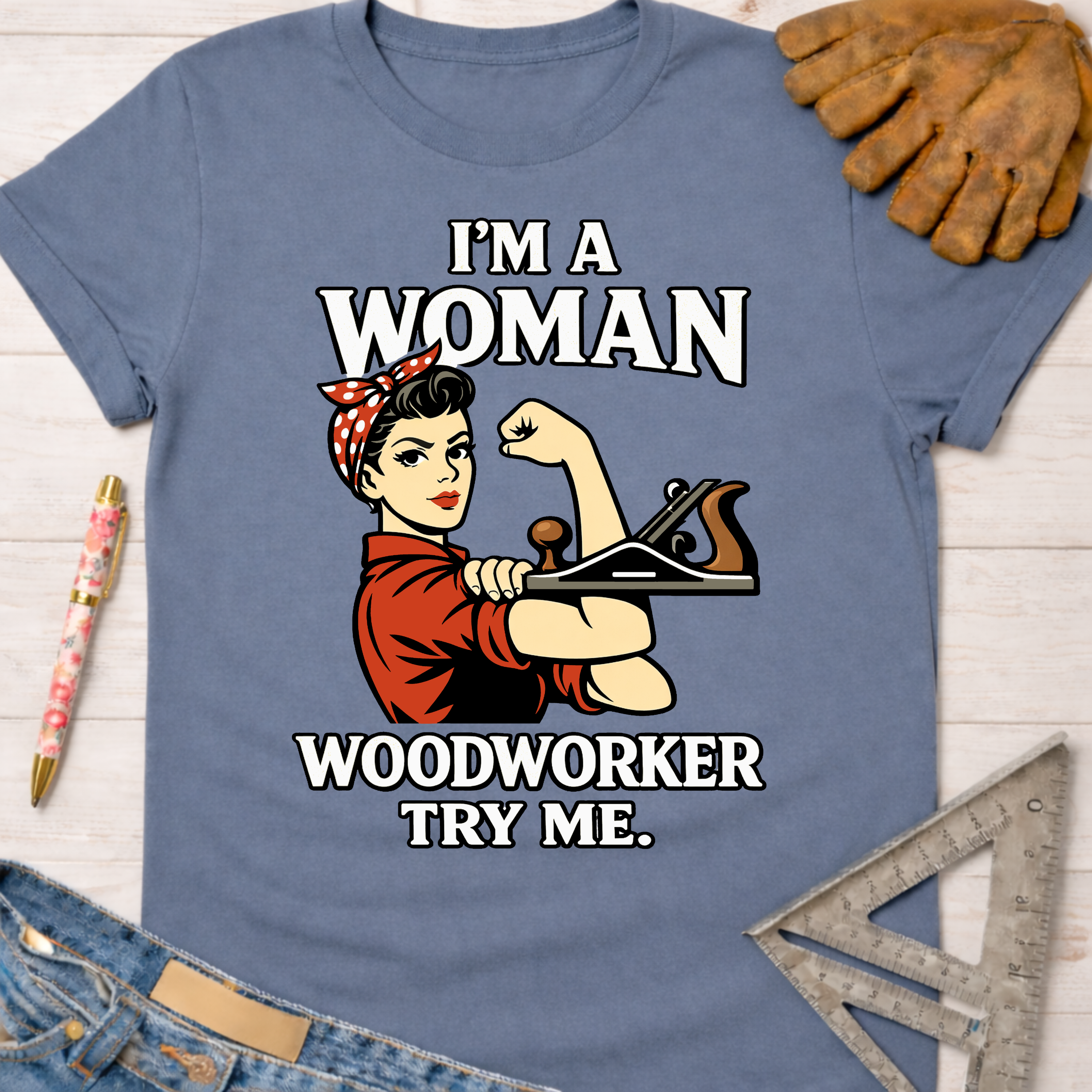 Women's funny woodworking graphic tee shirt for female woodworkers, makers, and DIY builders — Sawdust & Ponytails. Light blue cotton tee with Rosie the Riveter holding a wood plane.