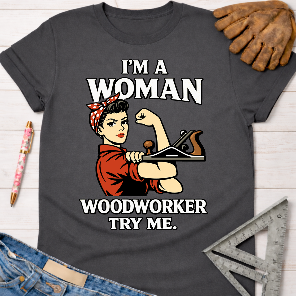 Charcoal gray cotton tee with "I'm A Woman Woodworker Try Me" and Rosie the Riveter holding a wood plane graphic.