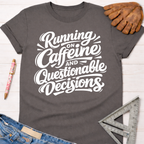 Women's funny woodworking graphic tee shirt for female woodworkers, makers, and DIY builders — Sawdust & Ponytails. Dark gray cotton tee with "Running on Caffeine and Questionable Decisions" in white script.