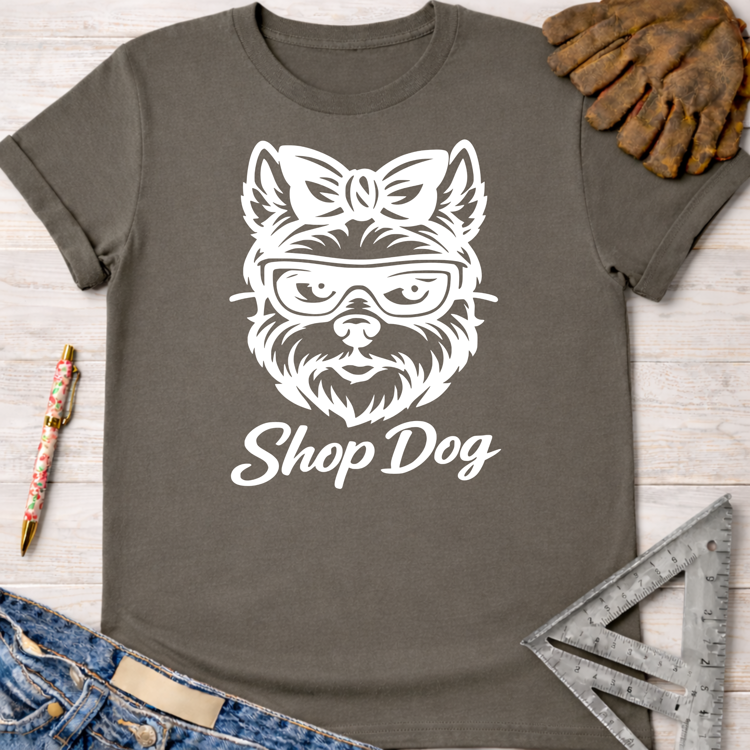Women's funny woodworking graphic tee shirt for female woodworkers, makers, and DIY builders — Sawdust & Ponytails. Dark gray cotton tee with white "Shop Dog" graphic.