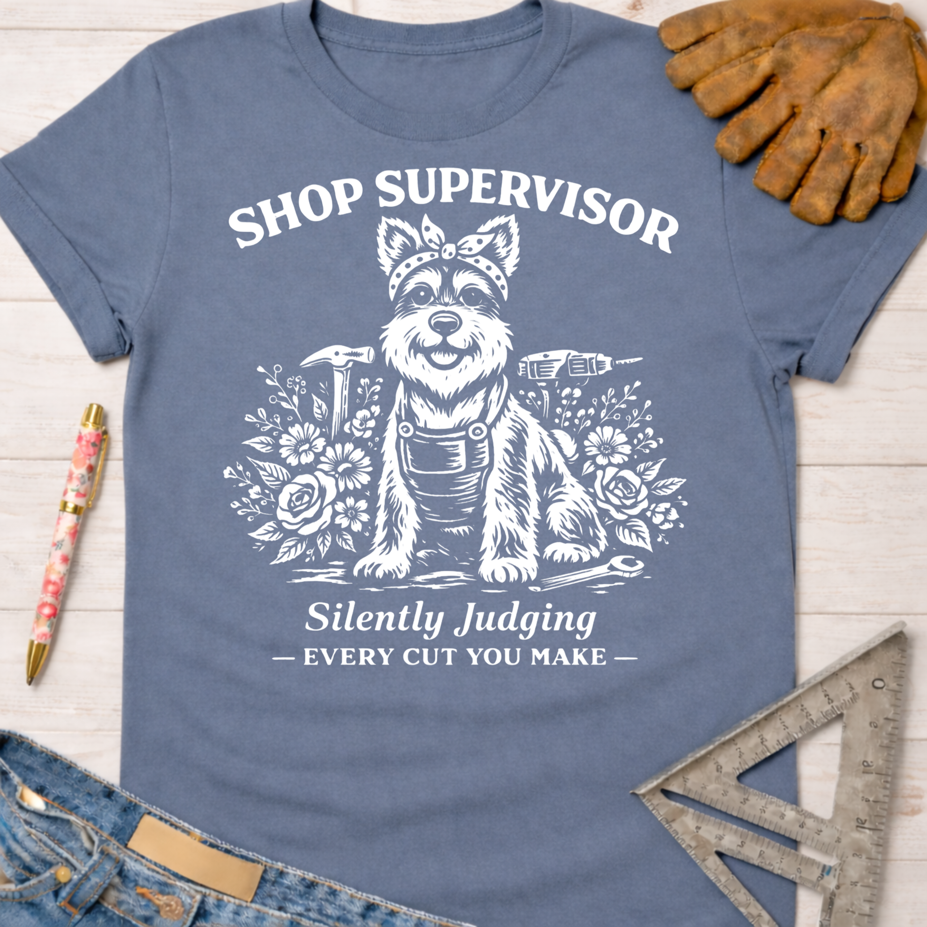 Women's funny woodworking graphic tee shirt for female woodworkers, makers, and DIY builders — Sawdust & Ponytails. Blue cotton tee with white "Shop Supervisor" dog design.