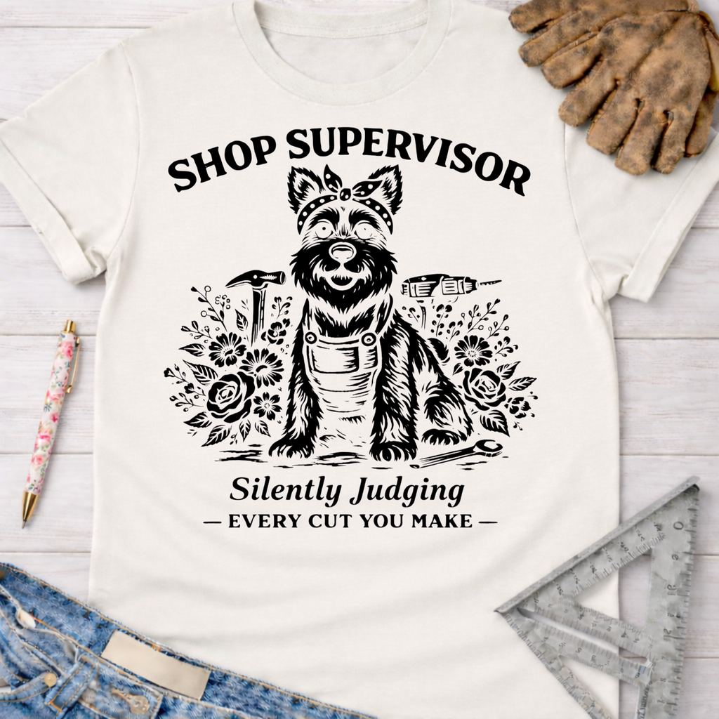 Women's funny woodworking graphic tee shirt for female woodworkers, makers, and DIY builders — Sawdust & Ponytails. White cotton tee with "Shop Supervisor Silently Judging" text and a dog graphic.