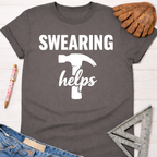 Women's funny woodworking graphic tee shirt for female woodworkers, makers, and DIY builders — Sawdust & Ponytails. Dark gray cotton tee with "SWEARING helps" and hammer graphic.