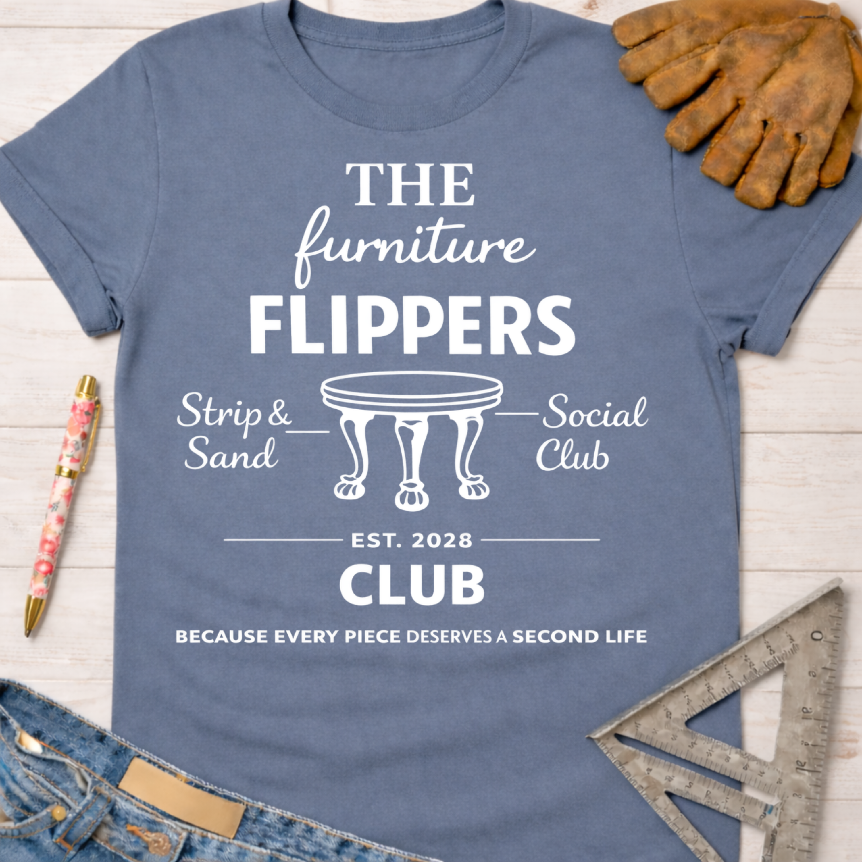 Women's funny woodworking graphic tee shirt for female woodworkers, makers, and DIY builders — Sawdust & Ponytails. Blue cotton tee with "The Furniture Flippers Social Club" design.