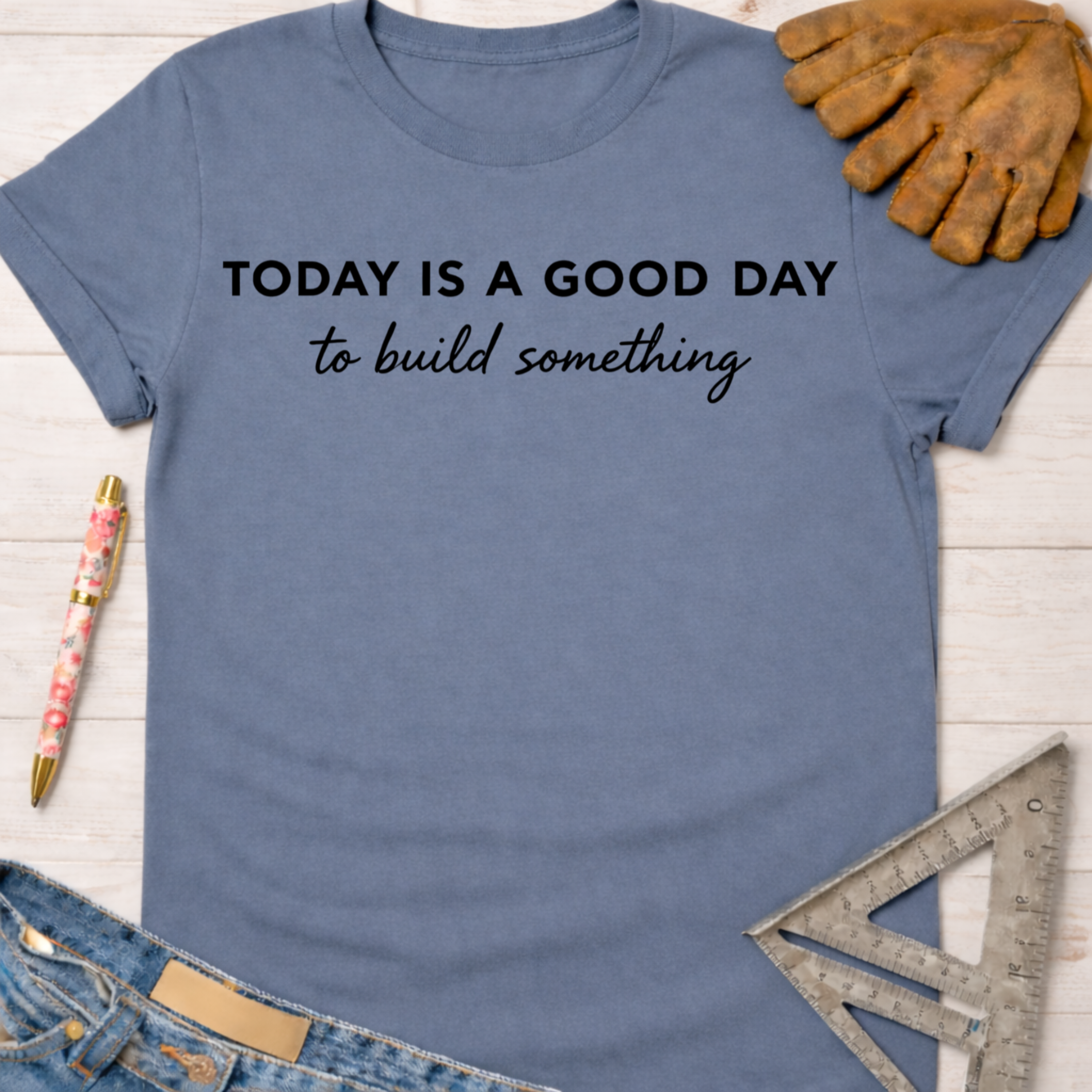 Women's funny woodworking graphic tee shirt for female woodworkers, makers, and DIY builders — Sawdust & Ponytails. Blue cotton t-shirt with "TODAY IS A GOOD DAY to build something" text.