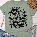 Sage green women's "Held Together by Wood Glue and Impure Thoughts" graphic tee. Women's funny woodworking graphic tee shirt for female woodworkers, makers, and DIY builders — Sawdust & Ponytails