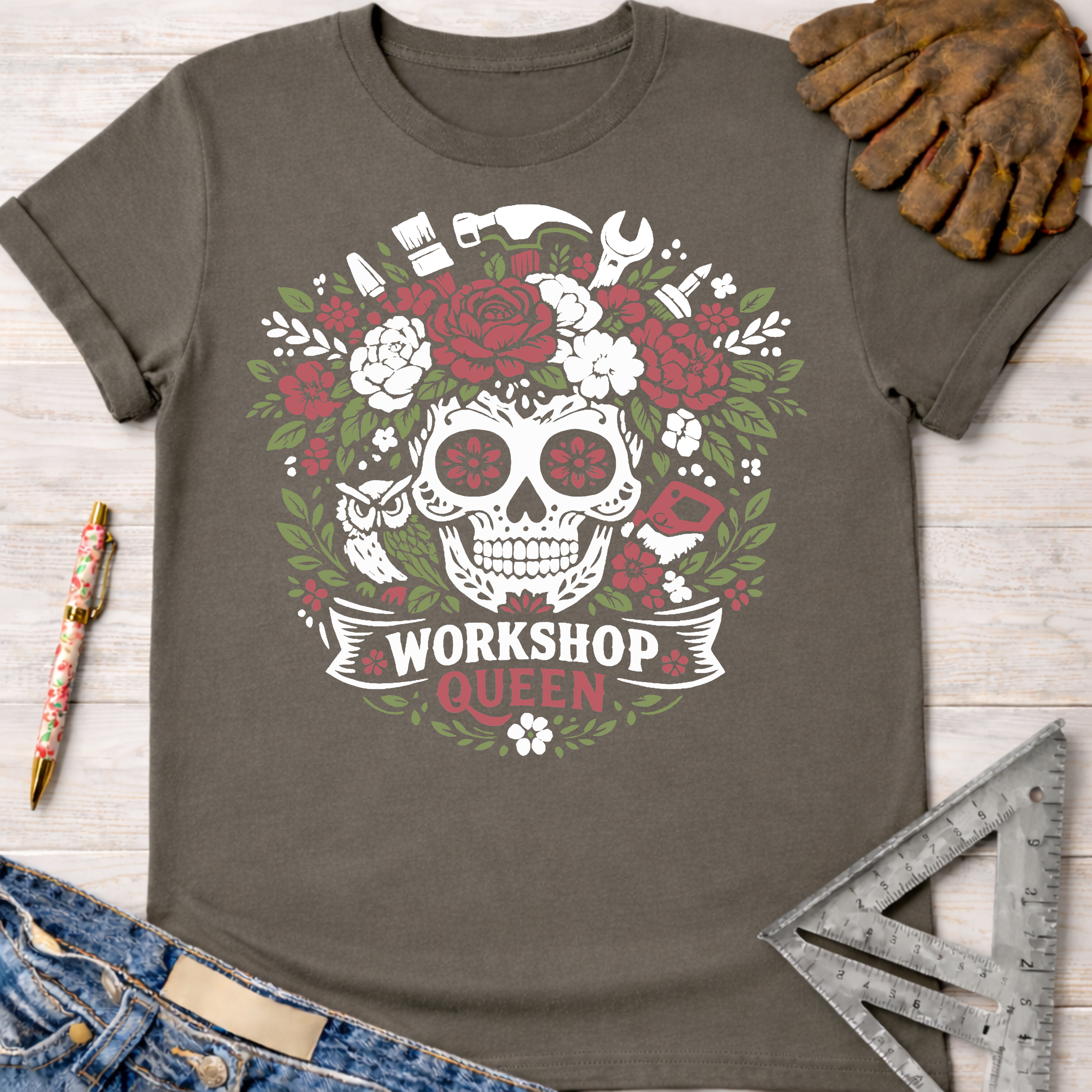 Charcoal grey t-shirt with a white and red floral skull, tools, and "Workshop Queen" graphic. Women's funny woodworking graphic tee shirt for female woodworkers, makers, and DIY builders — Sawdust & Ponytails
