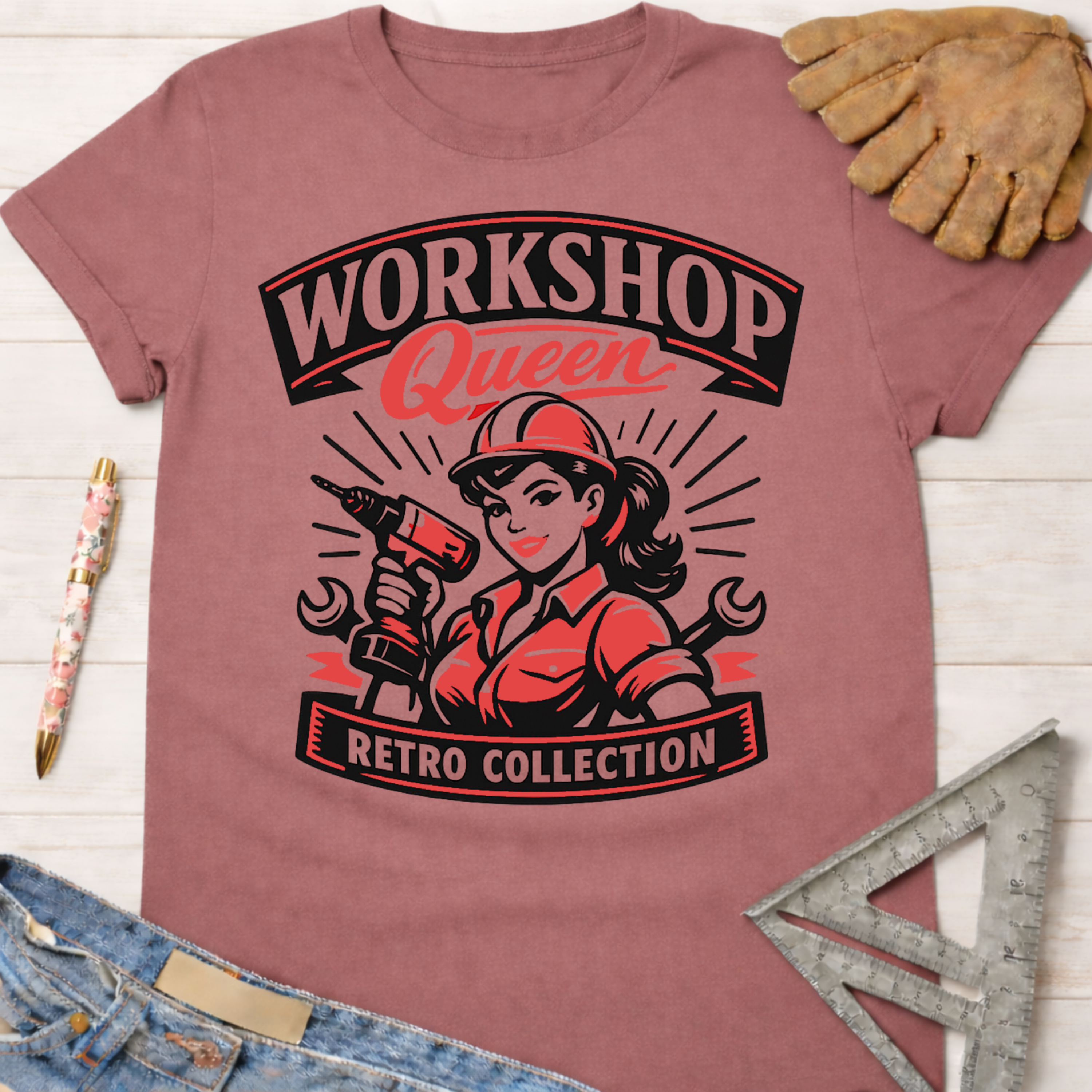 Women's funny woodworking graphic tee shirt for female woodworkers, makers, and DIY builders — Sawdust & Ponytails. Mauve retro t-shirt with "Workshop Queen Retro Collection" graphic featuring a woman in a hard hat holding a drill.