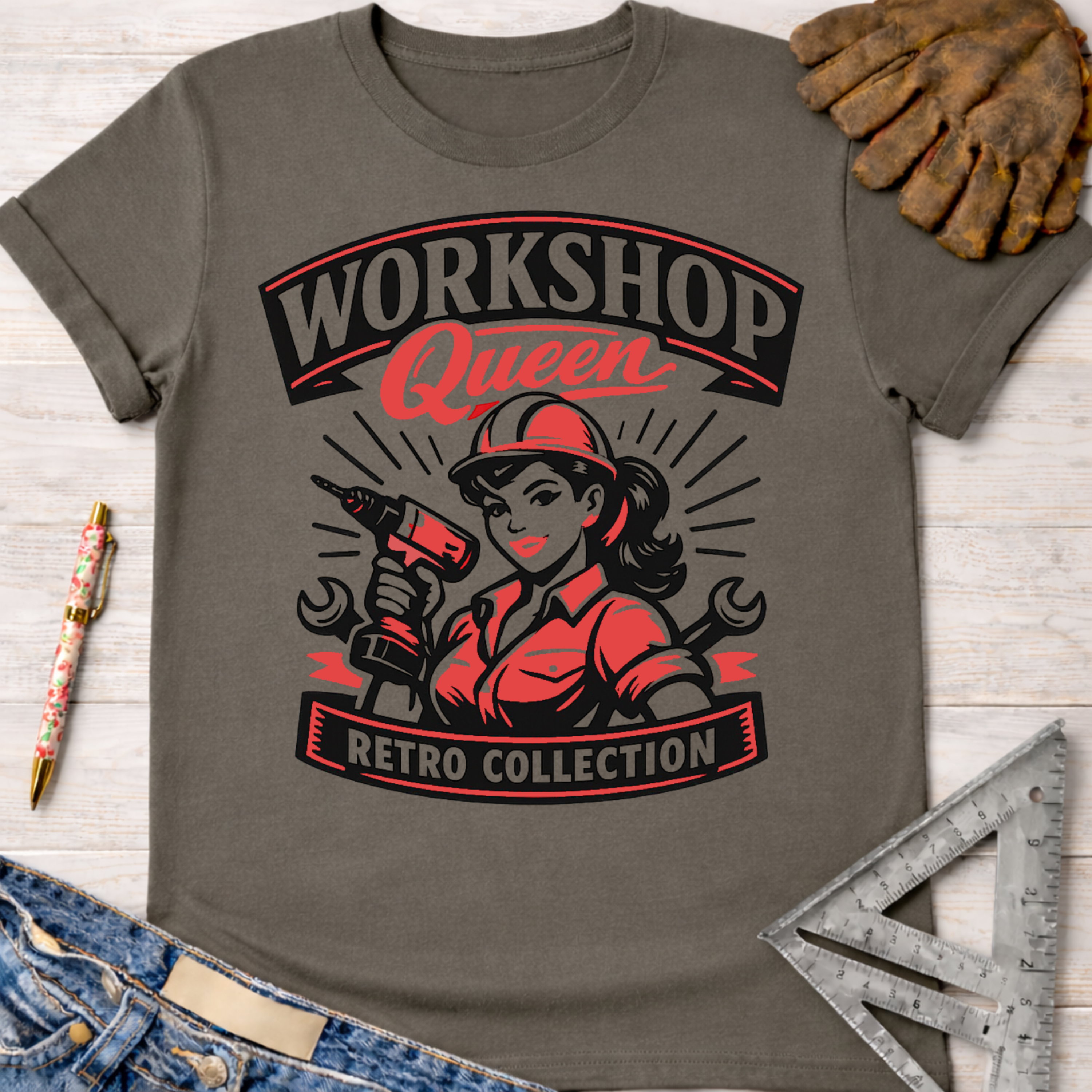 Women's funny woodworking graphic tee shirt for female woodworkers, makers, and DIY builders — Sawdust & Ponytails. Dark gray tee with "Workshop Queen Retro Collection" graphic featuring a woman with a drill.
