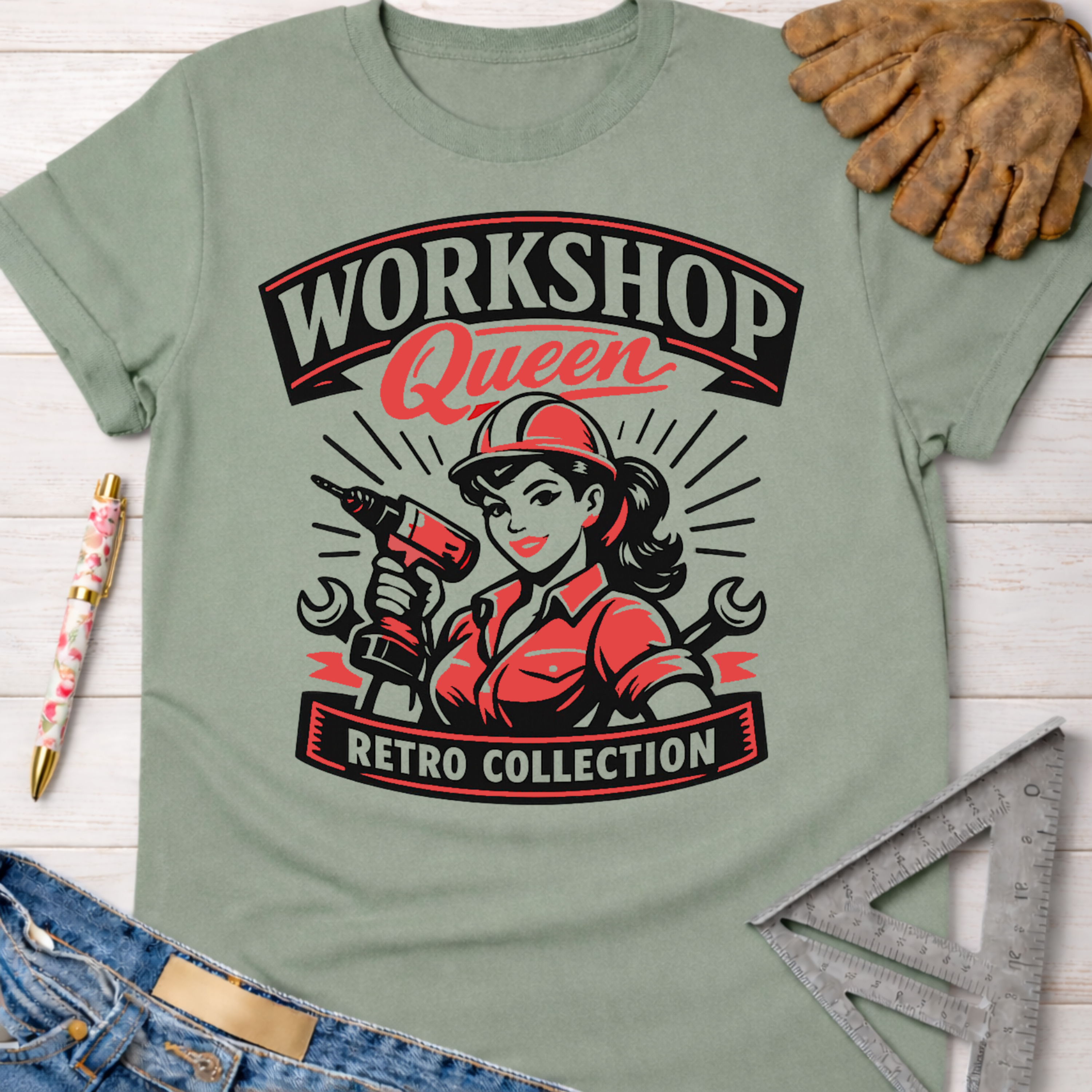 Women's funny woodworking graphic tee shirt for female woodworkers, makers, and DIY builders — Sawdust & Ponytails. Light green cotton tee with "Workshop Queen Retro Collection" graphic featuring a woman in a hard hat holding a drill.
