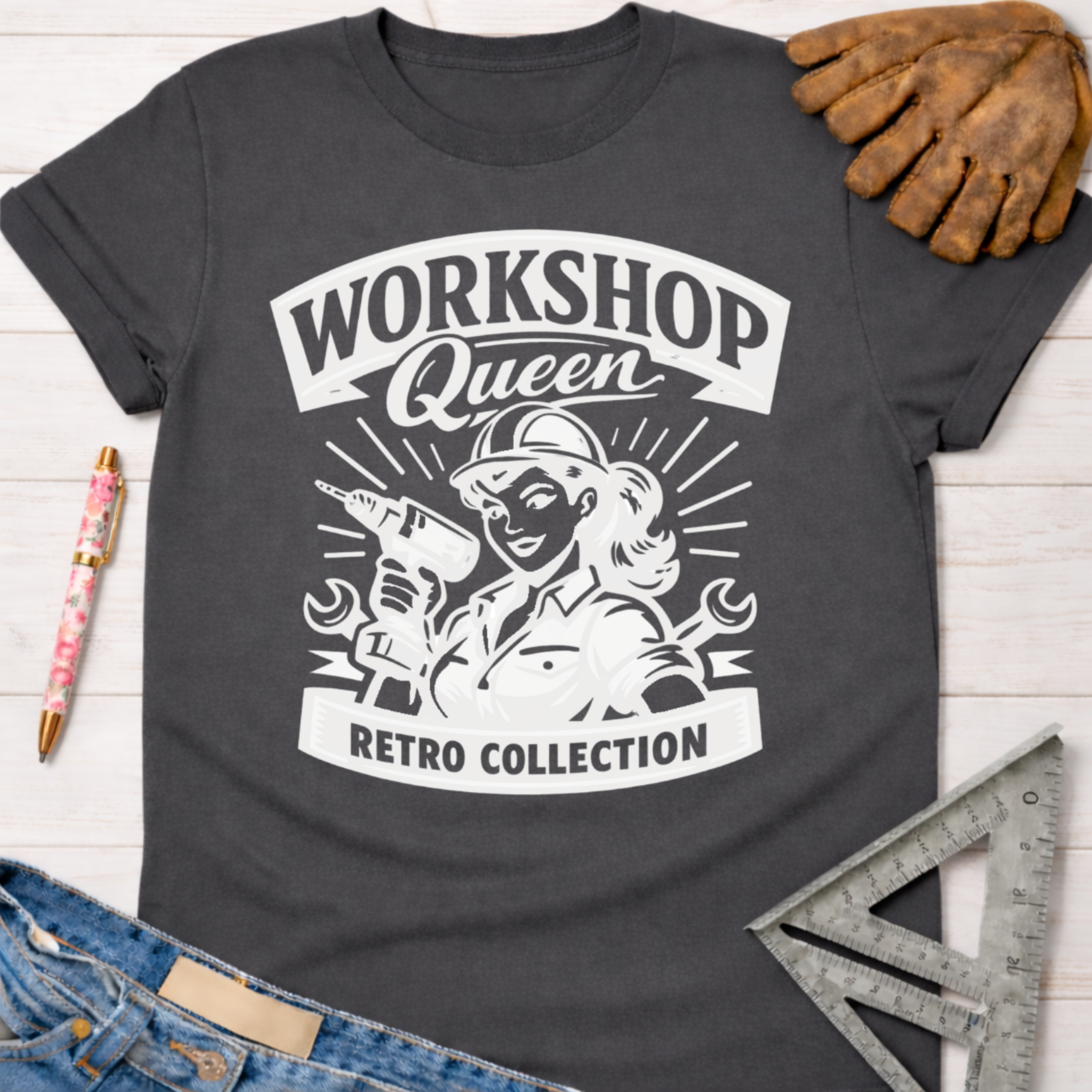 Charcoal grey women's "Workshop Queen Retro Collection" graphic tee with a vintage female woodworker holding a drill. Women's funny woodworking graphic tee shirt for female woodworkers, makers, and DIY builders — Sawdust & Ponytails